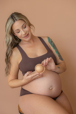 blond woman holding ovarium conception cup